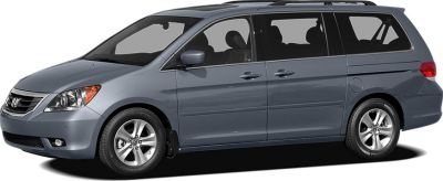Side profile of a grey minivan with sliding rear doors and alloy wheels
