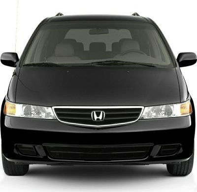 Front view of a minivan with grille, headlights, and smooth design