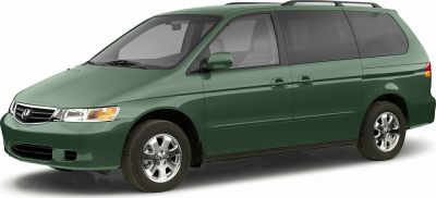 Front side view of a minivan with sliding rear doors and alloy wheels