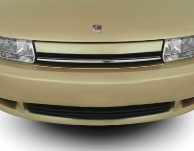 Close-up of front grille and clear rectangular headlights