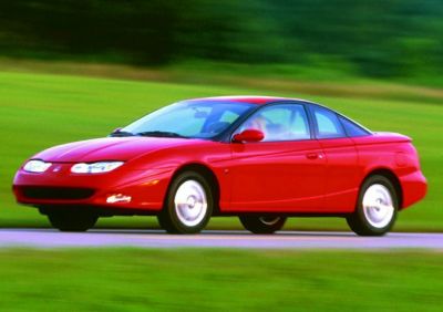 Red coupe on road with sleek aerodynamic design in motion