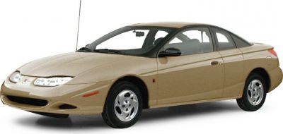 Beige coupe showing front side view with aerodynamic headlights and sleek body design