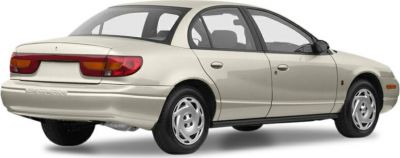 Rear and side of beige compact sedan with distinctive taillights and four doors