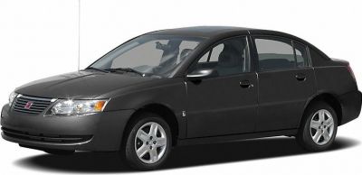 Four-door sedan side profile with front headlights and alloy wheels