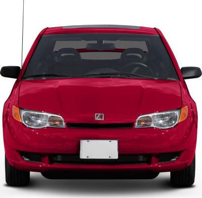 Front view with distinctive headlights and grille of compact coupe