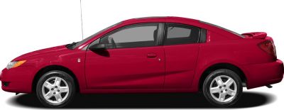 Side view of red 4-door coupe with sporty rear spoiler and alloy wheels