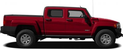 Side profile of pickup truck with extended cab and off-road tires