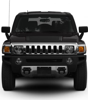 Front view featuring vertical slat grille and round headlights