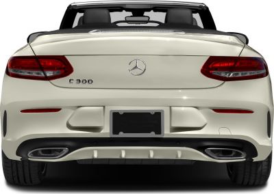 Rear view of a convertible with illuminated taillights and dual exhaust outlets
