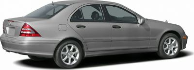 Side profile of a mid-2000s four-door sedan with alloy wheels