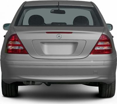 Rear view of a sedan with taillights, rear windshield, and bumper