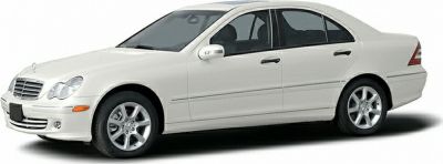 Side profile of a white sedan with alloy wheels and four doors