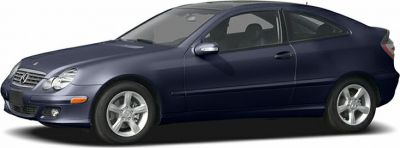 Side profile of a sleek two-door coupe with alloy wheels