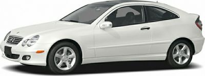 White two-door coupe with sporty alloy wheels and tinted windows