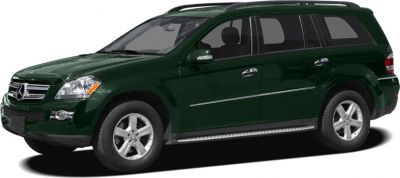 Side profile view of a dark green SUV with alloy wheels and running boards.