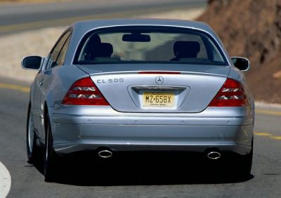 Rear view of luxury coupe with dual exhaust and distinct tail lights