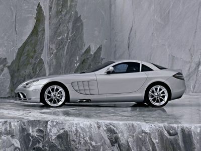 Side profile of a silver coupe with aerodynamic vents and alloy wheels.