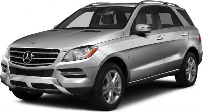 Front side view of silver luxury SUV with prominent grille and headlights