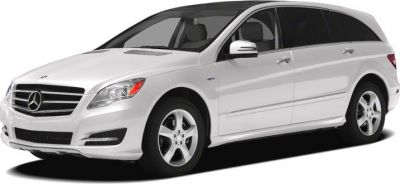 White luxury long-wheelbase van with distinctive grille and alloy wheels
