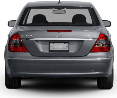 Rear view of sedan with E320 and Bluetec badges, distinct tail lights, and trunk design.