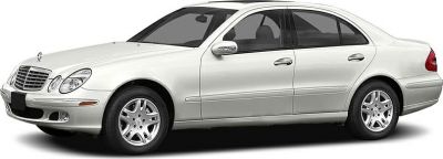Silver luxury sedan with oval headlights and alloy wheels, front-side profile.