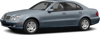 Side profile view of mid-2000s luxury sedan with alloy wheels.