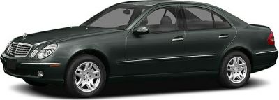 Side profile of a luxury sedan with alloy wheels and classic 2000s design.