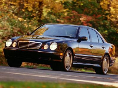 Front side view of a luxury sedan with round headlights and classic grille