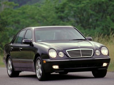 Mid-size sedan with dual round headlights and chrome grille.