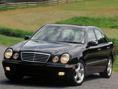 Front view of a sedan with dual round headlights and chrome grille