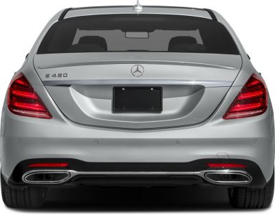 Rear view showing LED tail lights and dual exhaust tips on luxury sedan.
