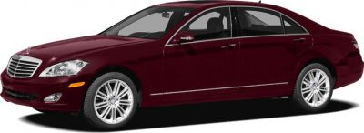 Luxury sedan front side profile with wheels, headlights, and chrome grille