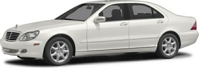 White sedan side profile showcasing smooth design and alloy wheels.