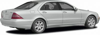 Rear side profile of elongated luxury sedan with distinct tail lights
