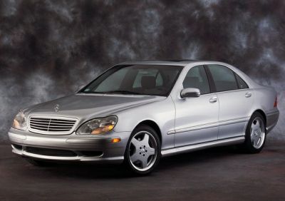 Silver luxury sedan front side view with alloy wheels and sleek design