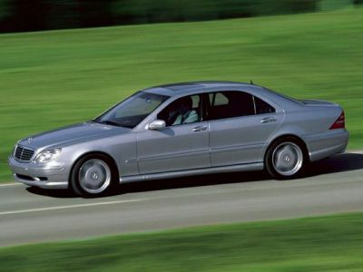Side profile of a silver elongated luxury sedan with alloy wheels.