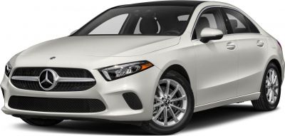 Front three-quarter view of a white sedan with distinctive grille and headlights
