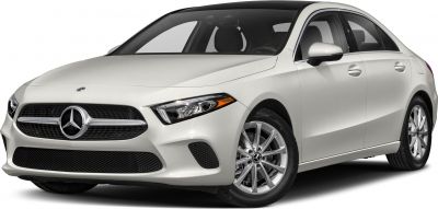 White sedan with prominent front grille and alloy wheels