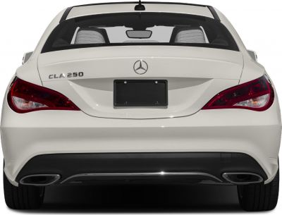 Rear view showing distinct tail lights and dual exhausts of a coupe.
