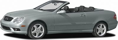 Silver convertible car with soft top and alloy wheels.