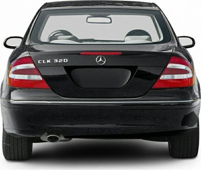 Rear view of a Mercedes-Benz coupe with taillights and single exhaust.