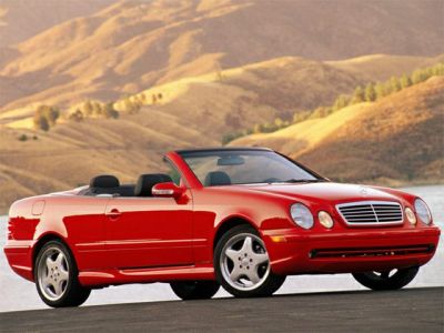 Red convertible with round headlights and chrome grille