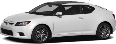 White two-door coupe with alloy wheels and black roof panel