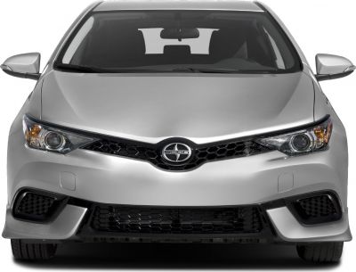 Close-up of car front with headlights and honeycomb grille.