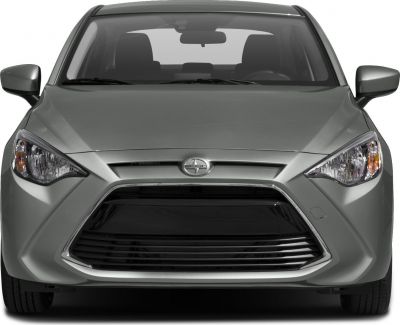 Sharp headlights and bold front grille of a compact sedan
