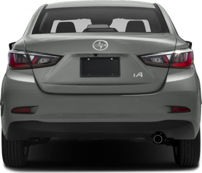 Compact sedan rear with signature tail lights and single exhaust pipe