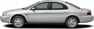 Side profile of a classic mid-2000s sedan with chrome wheels