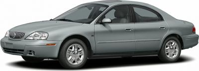 Side profile of a four-door sedan with chrome wheels and smooth body lines