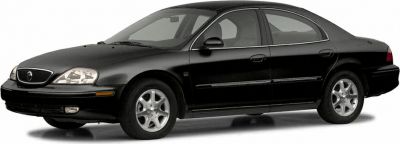 Black four-door sedan with alloy wheels, front side view