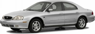Silver four-door sedan with front and side profile, alloy wheels, and streamlined shape